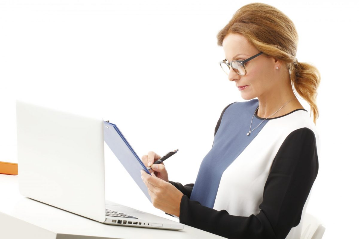 woman taking computer repair notes